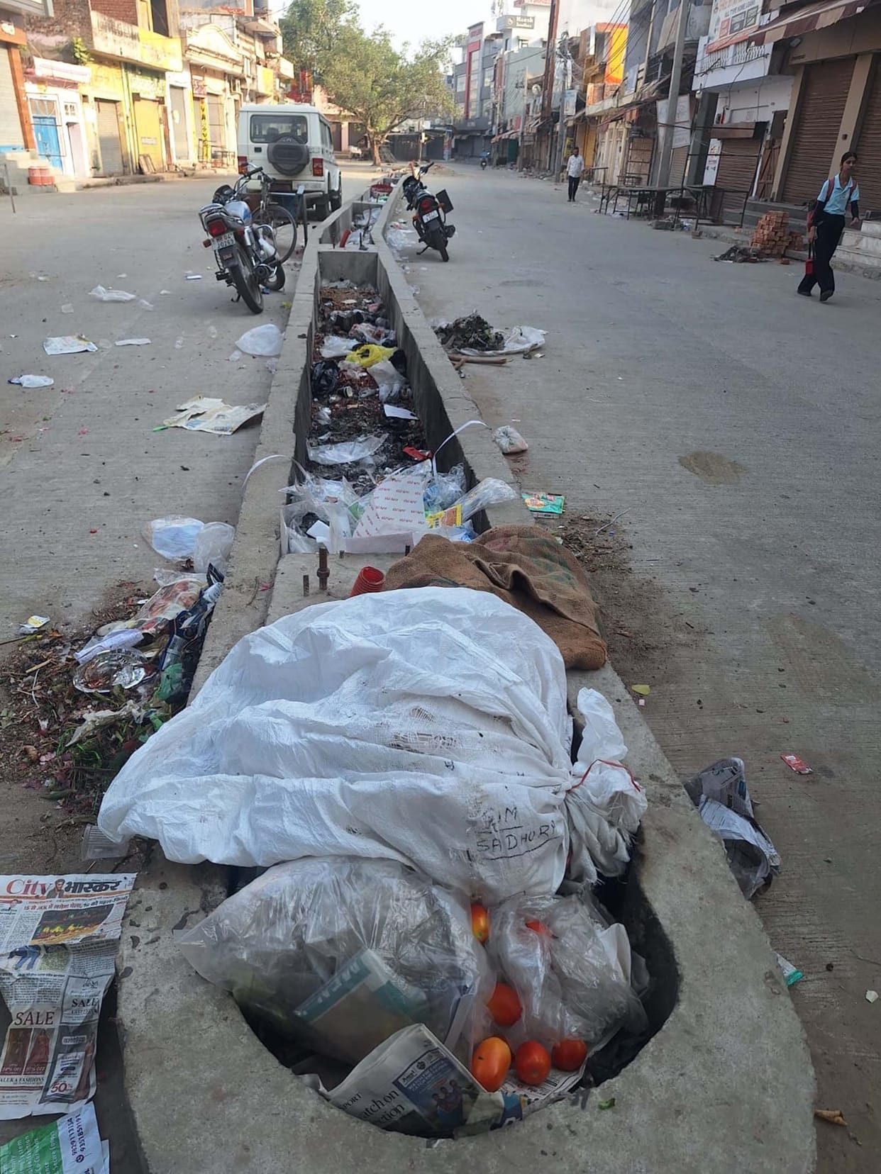 Heaps of garbage pile up on the divider in Sadhaura Market