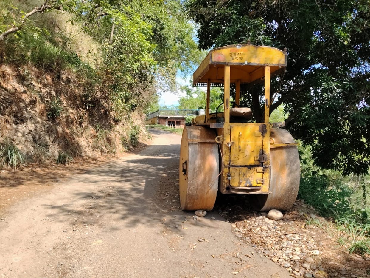 Traffic is affected due to the road roller parked on the roadside.