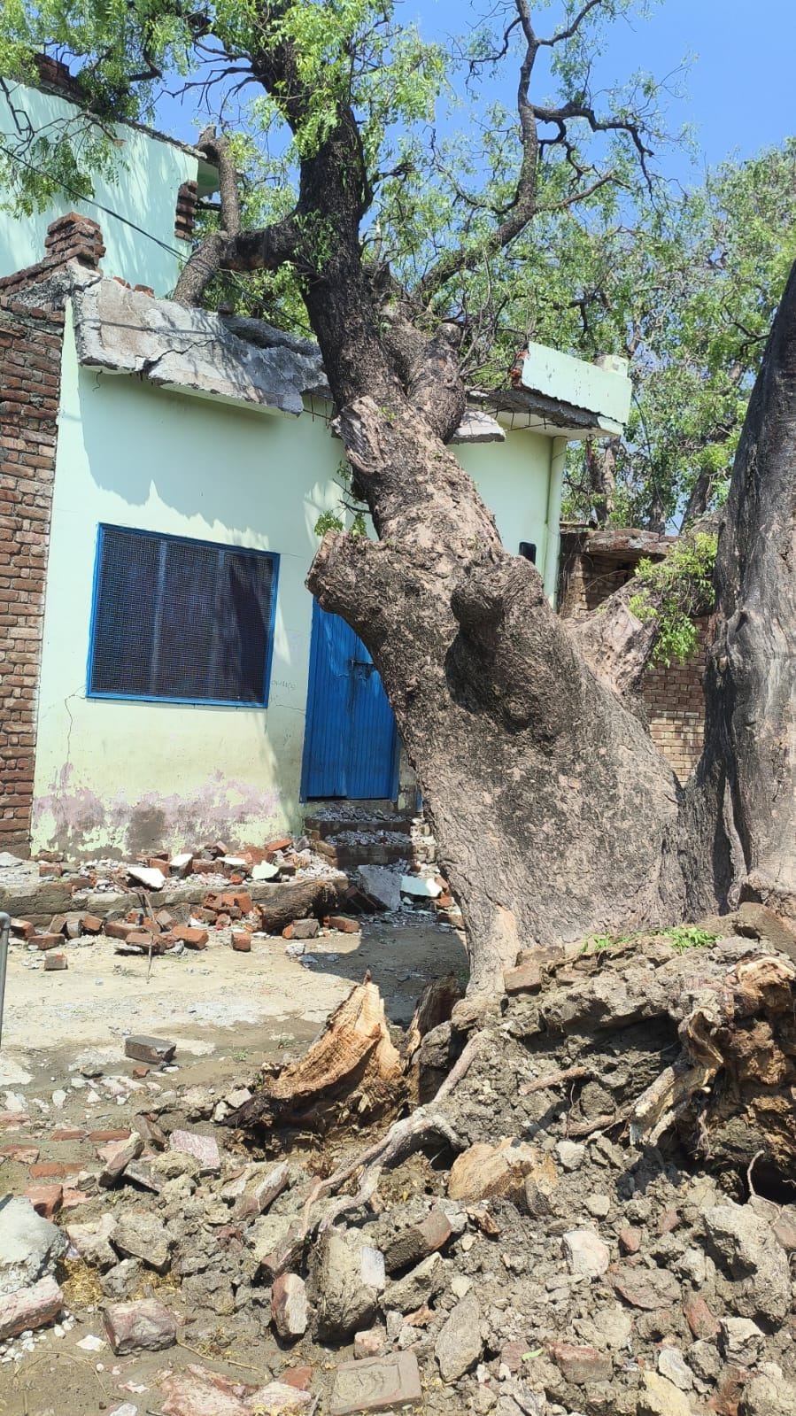 A wall collapsed in the storm and rain, killing a woman.