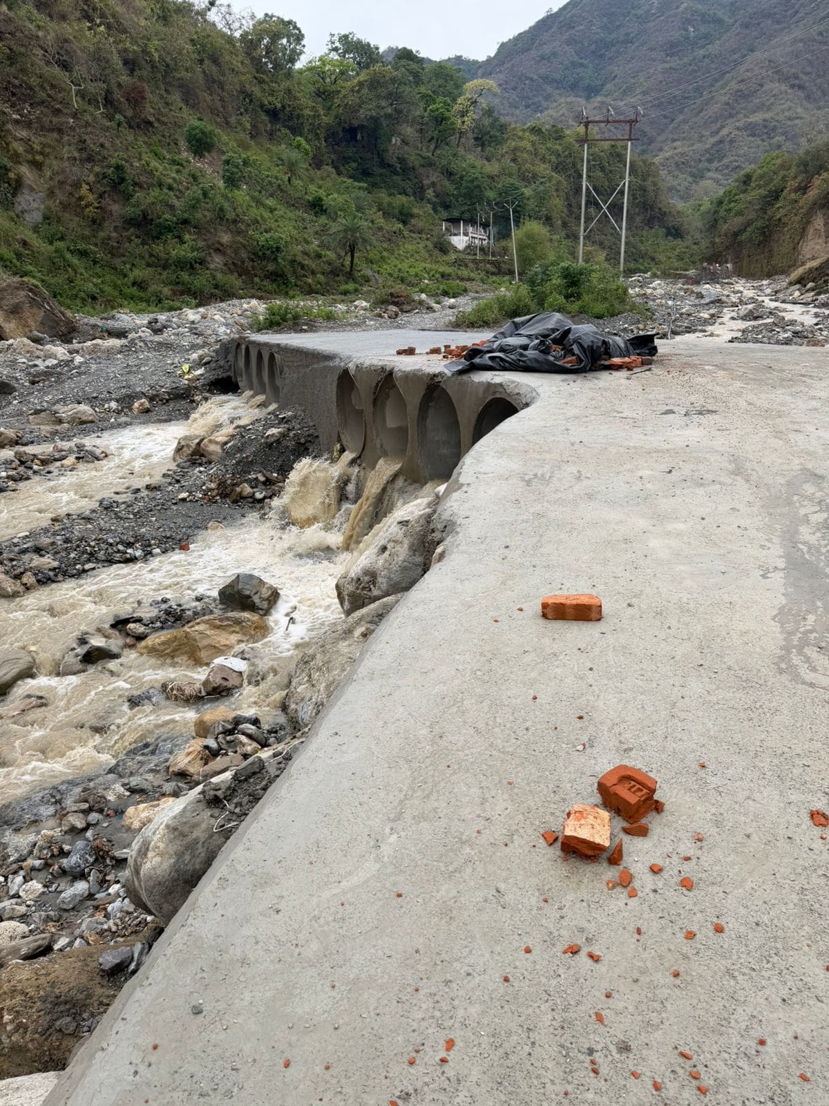 Municipal Corporation bulldozers demolish illegal bridge over Rispana River