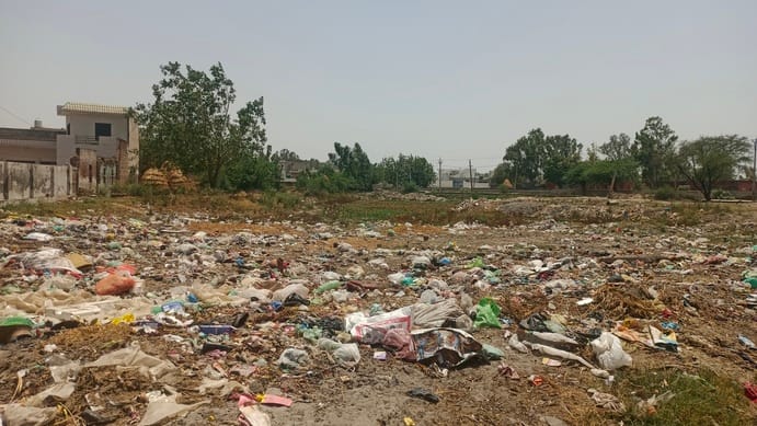 Heaps of garbage lie in the middle of the village, with no plans to remove it.