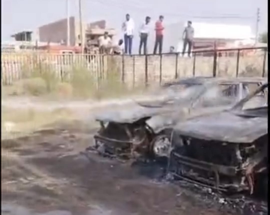 Vehicles parked outside the agency caught fire, three burned.