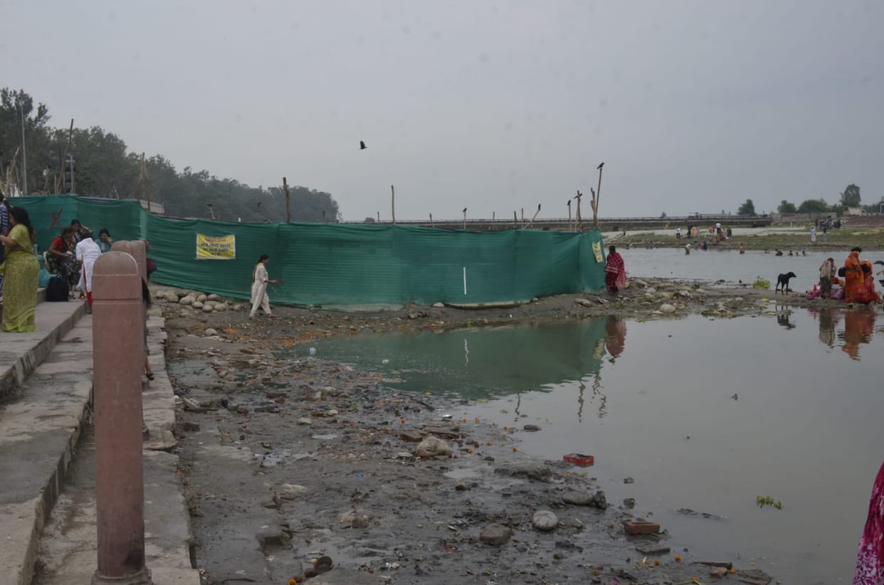 Silt accumulated from the pit on the ghat, spread dirt, sadhus will gather today