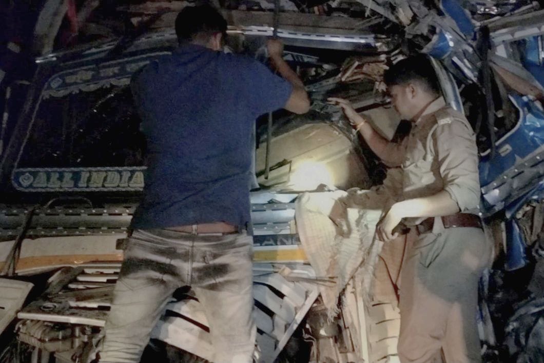 Liquor-laden truck collides with parked truck, driver and helper injured