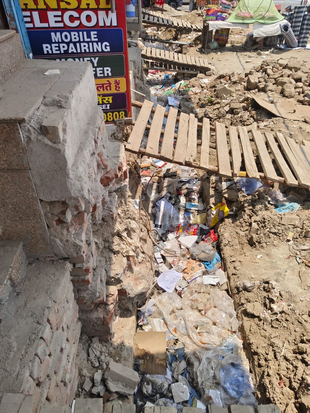 Business eclipsed by the path of development: Shopkeepers are distressed due to open drains and heaps of mud at Bahalgarh Chowk.