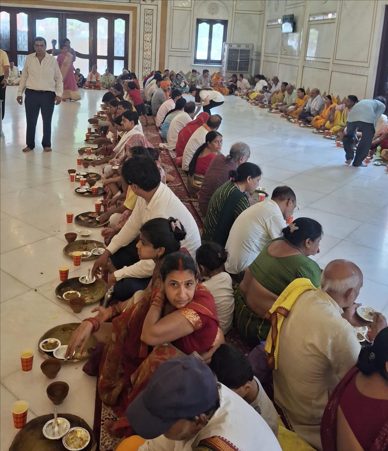 132 Brahmin couples were honored and given a feast at the Tridev Temple