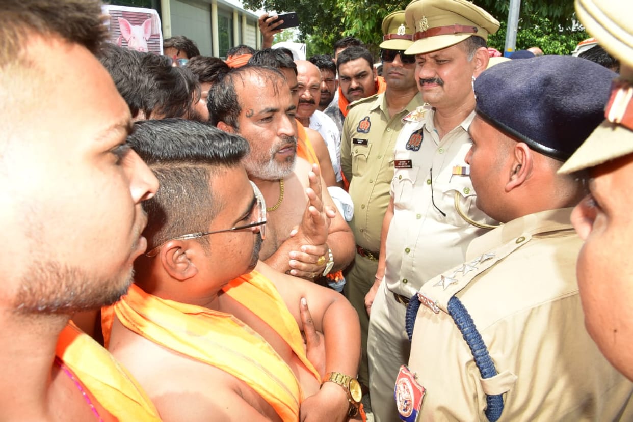 Hindu Raksha Dal activists staged a protest while stripped to the waist.