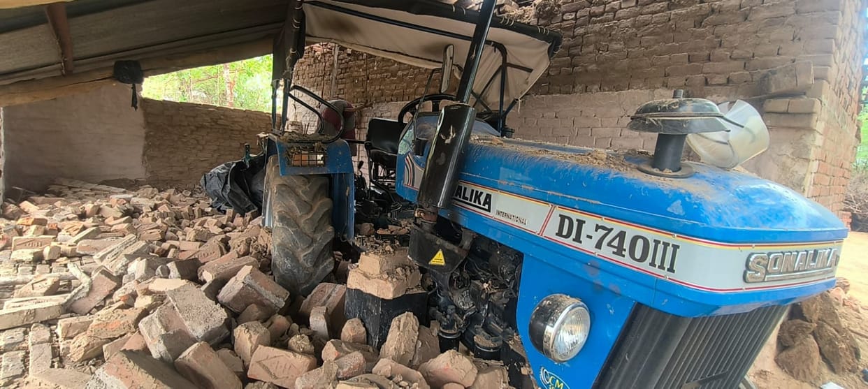 A mud wall collapsed in a strong storm, injuring father and son.
