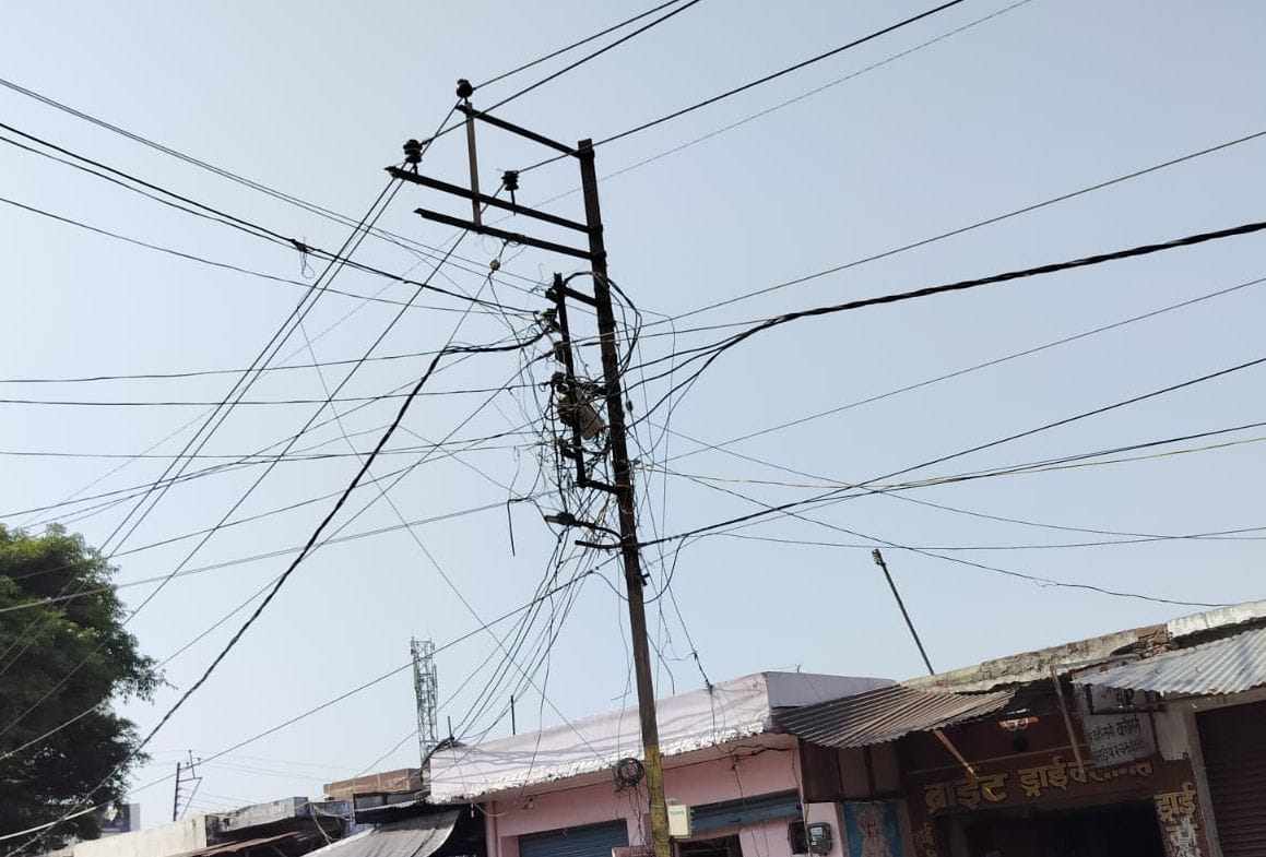 Life under the shadow of danger: High-tension wires dangling in the city streets.Life under the shadow of danger: High-tension wires dangling in the city streets.