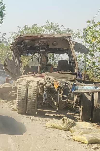 Cement-laden truck falls from road onto highway; father and son injured; traffic disrupted for an hour.