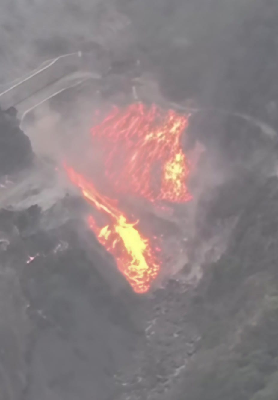 Flames from the forest reached the houses; people rushed with buckets to douse the fire.