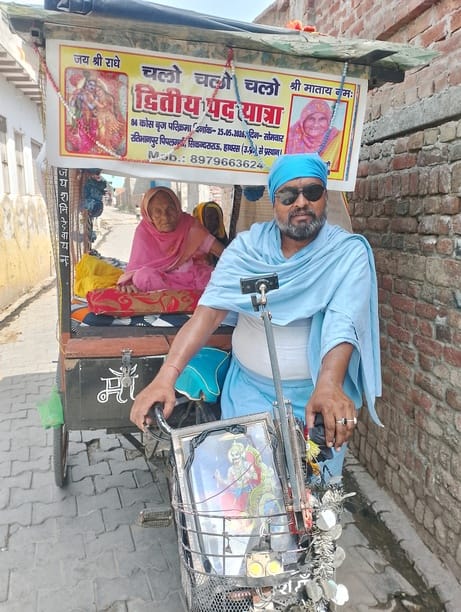 Elderly son fulfills his elderly mother's wish by pulling a handcart.
