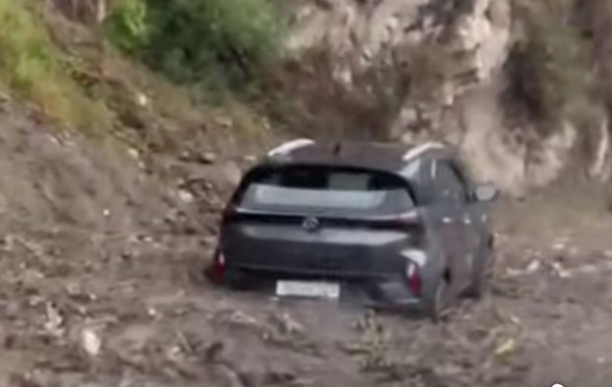 A torrent of mud and stones surged into the drain, sweeping up a car; traffic was disrupted for an hour.
