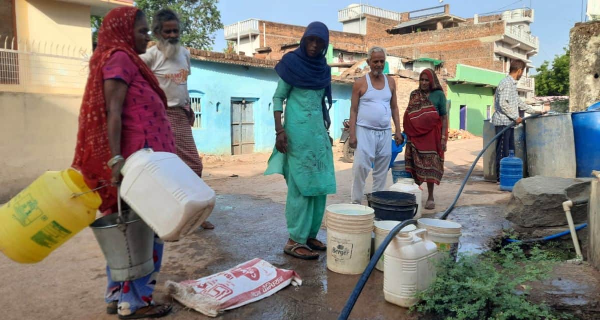 फोटो 10 एमएएचपी 10 परिचय-पेयजल आपूर्ति ठप होने से पड़ोसी के सबमर्सिबल पंप से पानी भरते लोग। संव