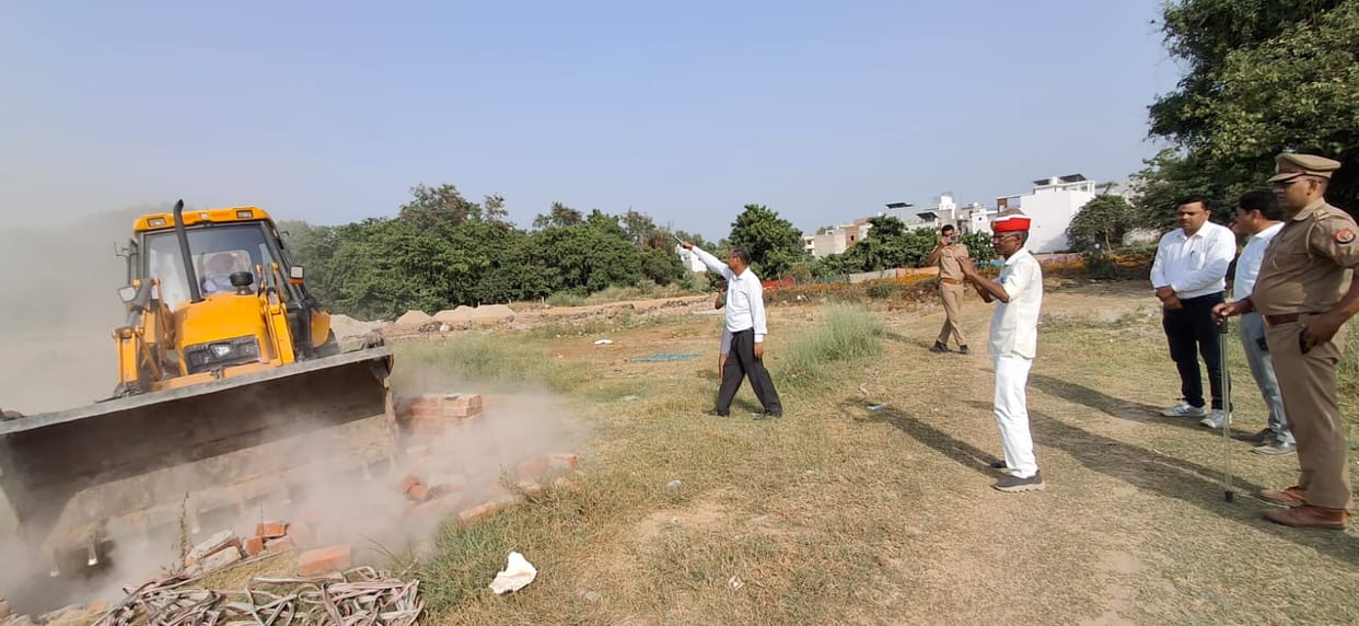 Structures in an illegal colony were demolished using a bulldozer.
