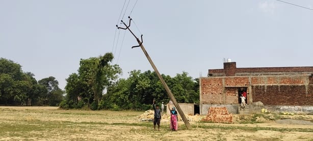 Dilapidated pole leaning near tubewell; risk of accident.