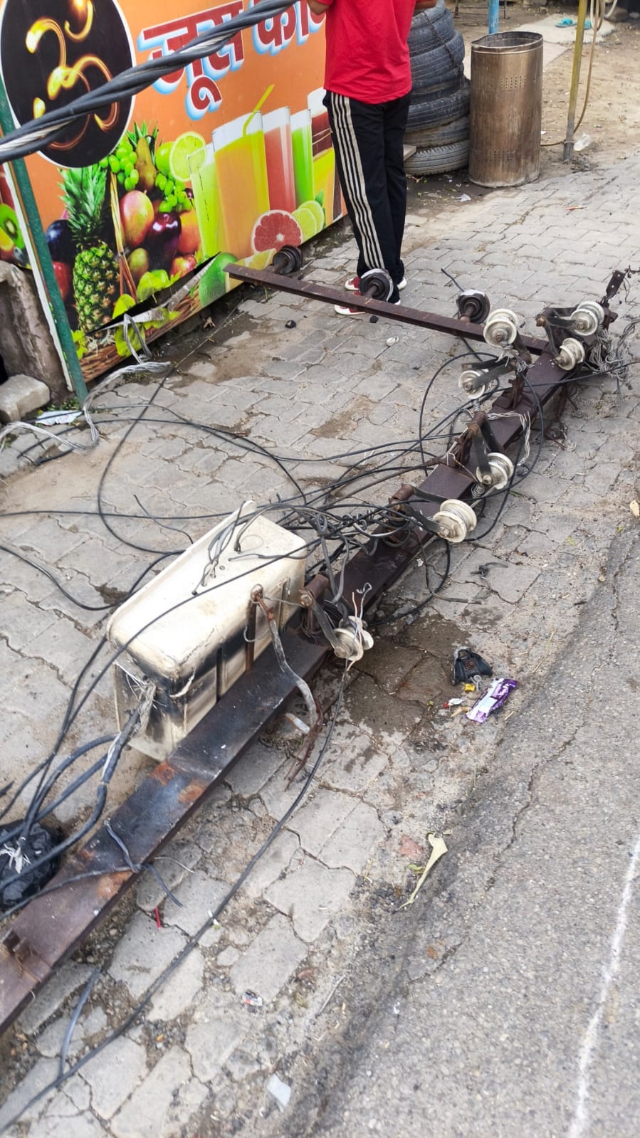 High-tension line pole falls amidst moving vehicles; several drivers suffer electric shocks.