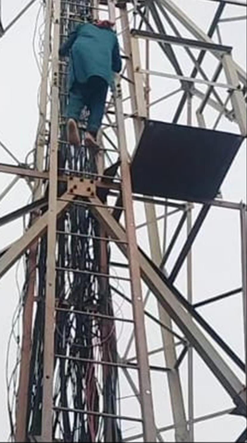 Climbed a 70-foot-high mobile tower over a romantic affair; came down after three hours.