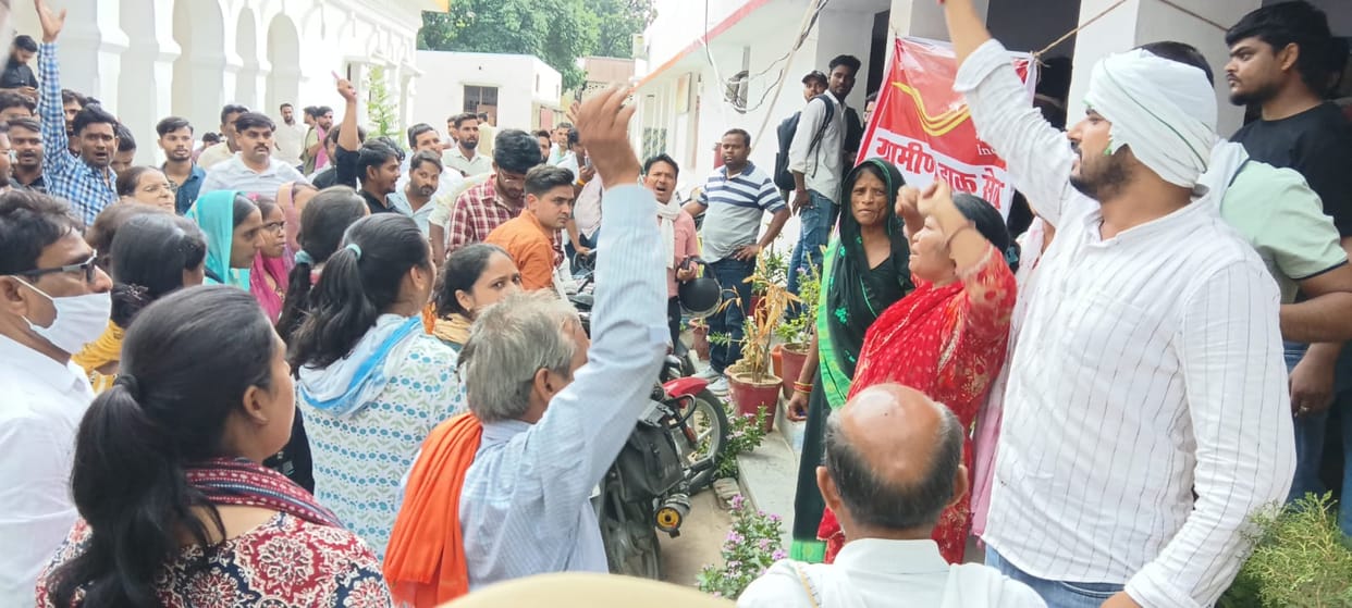 Outraged by a colleague's death, employees surrounded the Postmaster's office.
