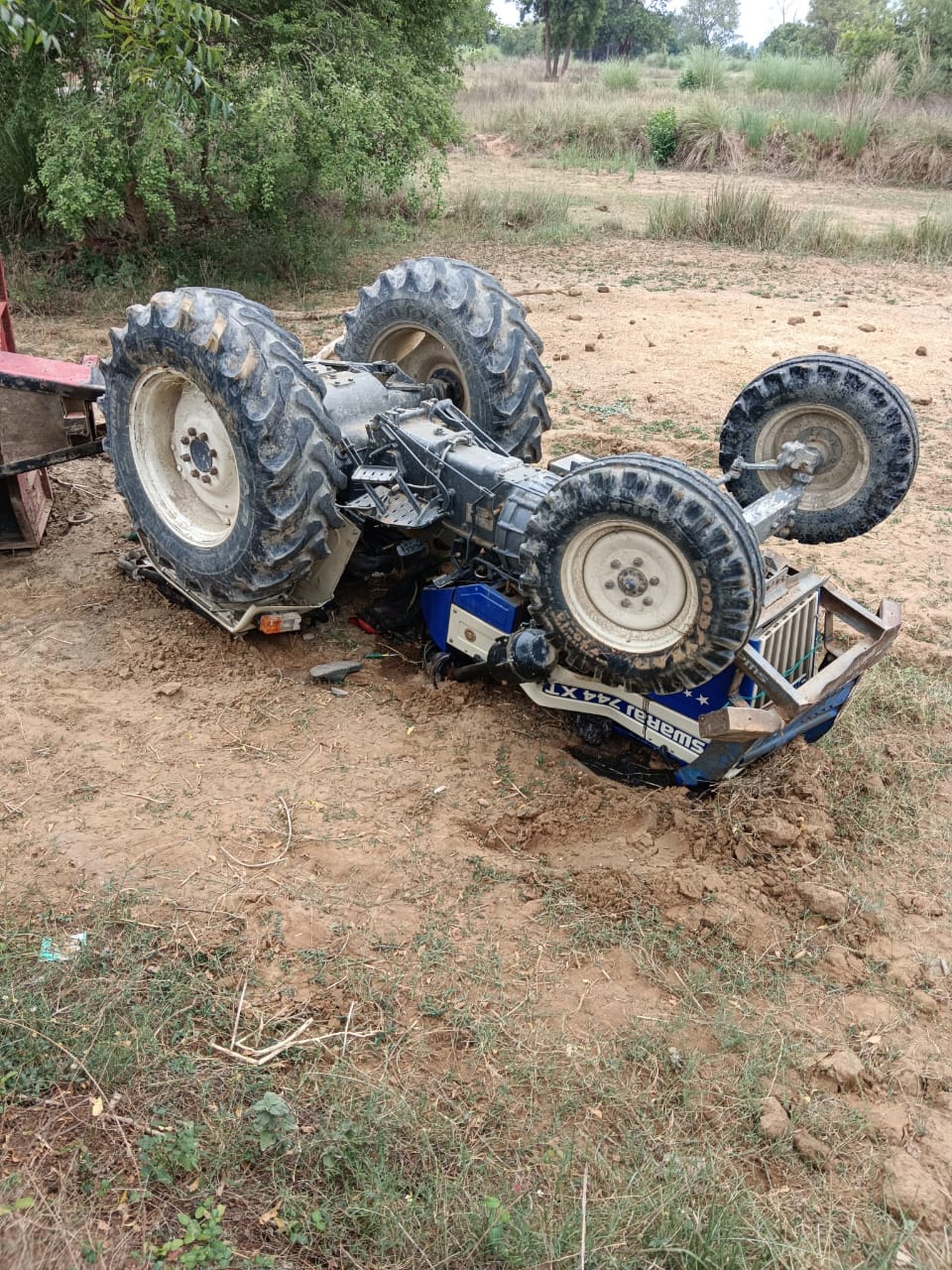 Tractor-trolley overturns; driver saves life by jumping out.