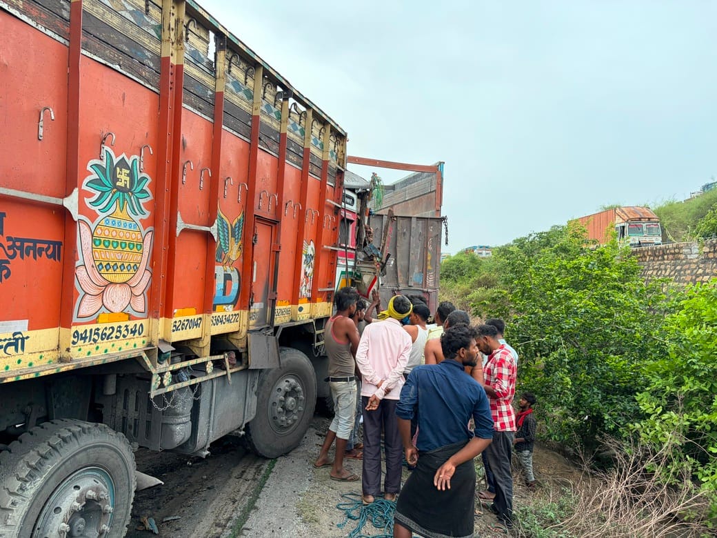 Truck rams into stationary truck from behind; driver injured.