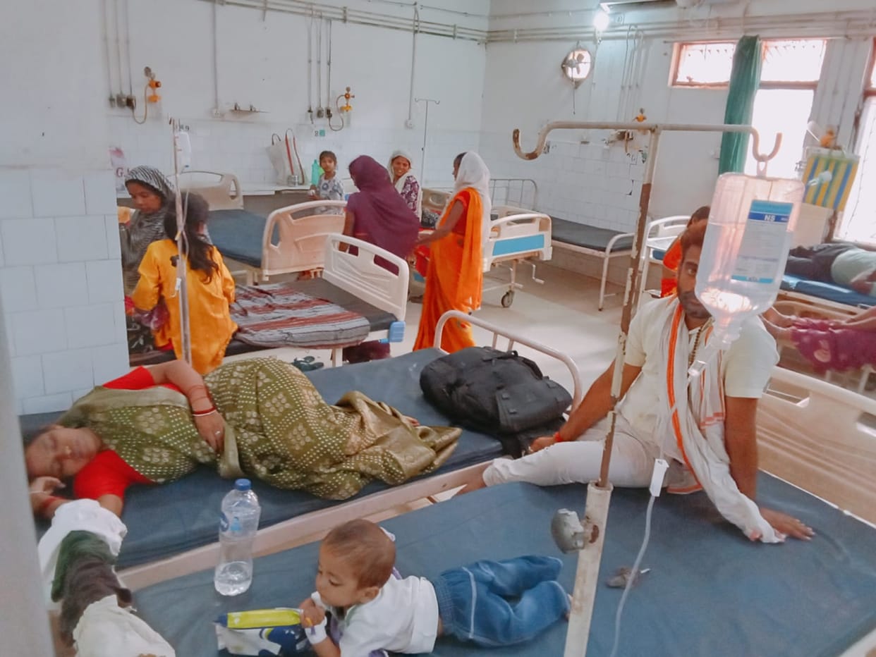 Changing weather affects children's health; two children being treated on a single bed.