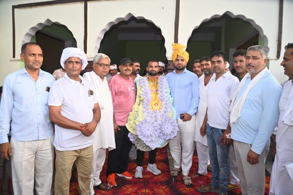 Wrestler Deepak was honored after winning medals in two championships.