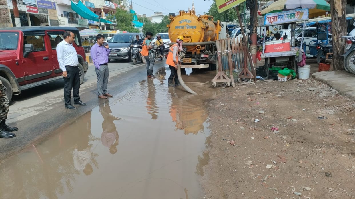 Drains overflow on Shamsabad Road; filthy water floods the street.