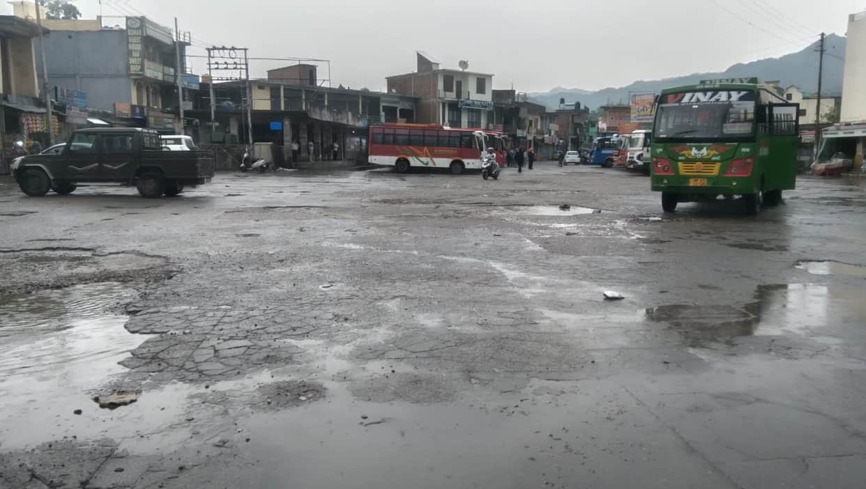 Jahu bus stand turns into a 'hub of potholes'; rainwater adds to passengers' woes.