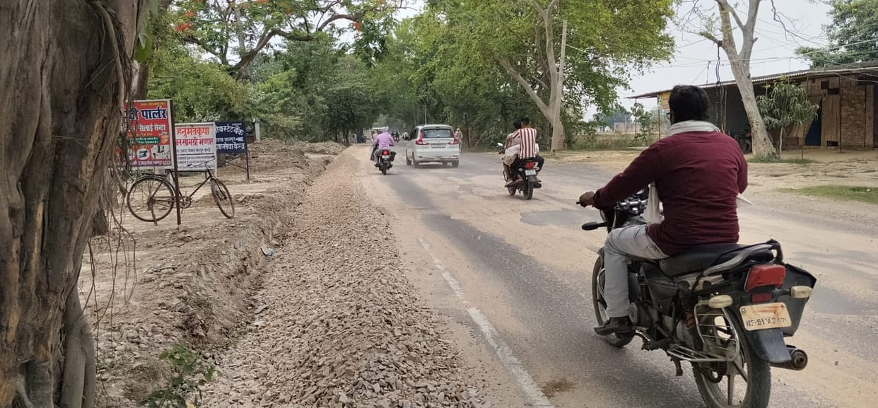 Dust billowing from the road under construction; people are choking.