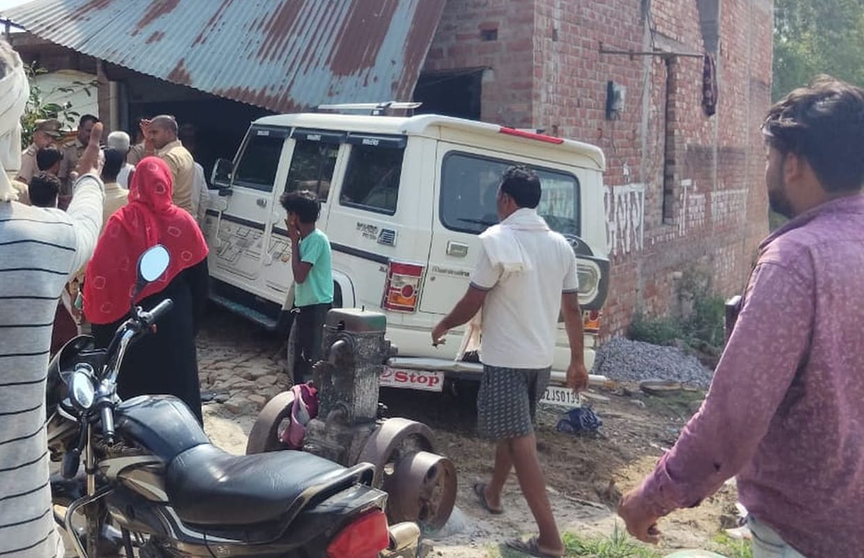 Bolero crashes into bike and moped before ramming into a house; three injured.