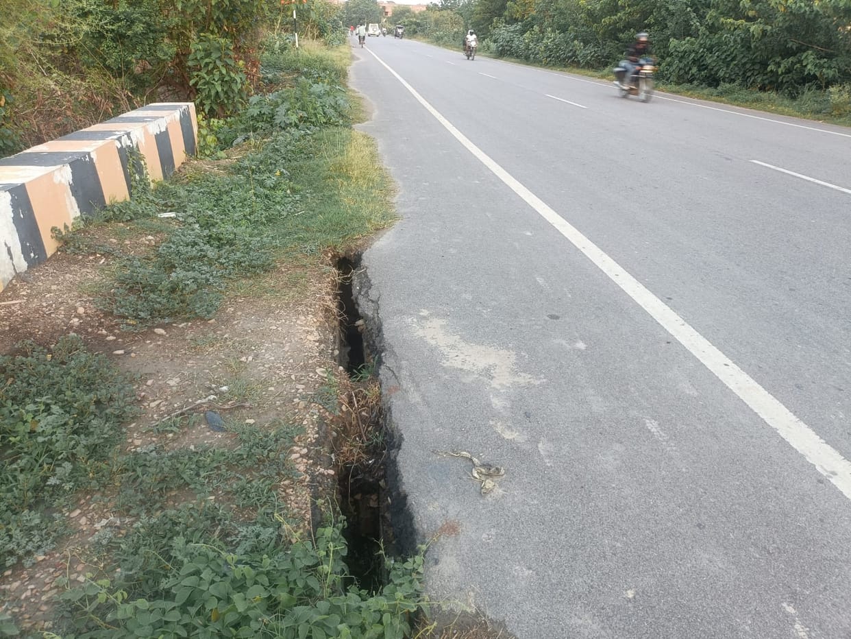 Crack in the road near the culvert; risk of accidents.