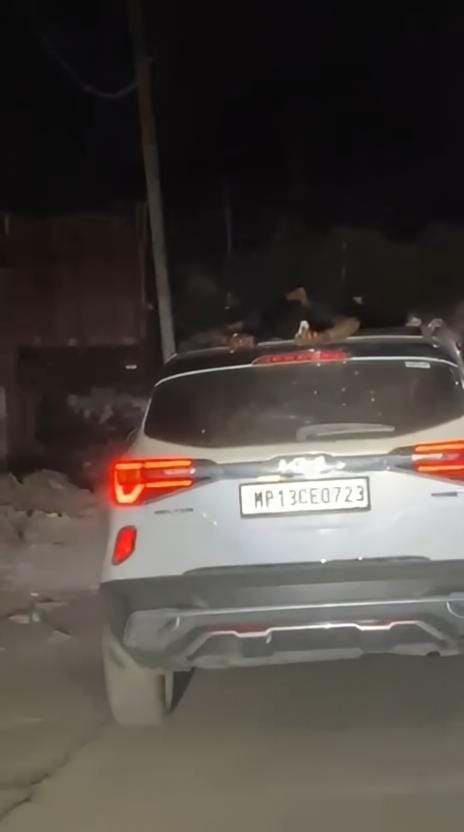 Death-Defying Stunt in Mahakal City: Man Films Video Lying on Car Roof, Police Teach Lesson