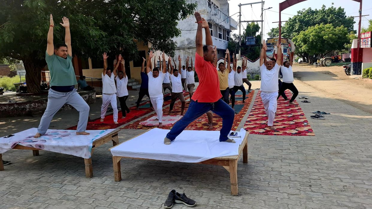Police personnel pledged to stay healthy by practicing yoga.