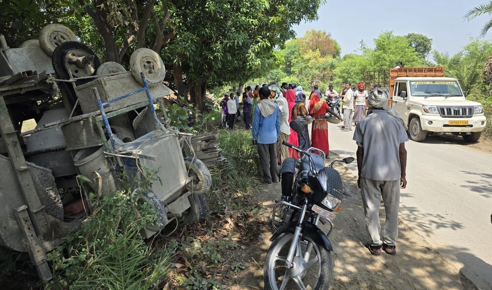 Loader machine overturned after being hit by a pickup, driver injured
