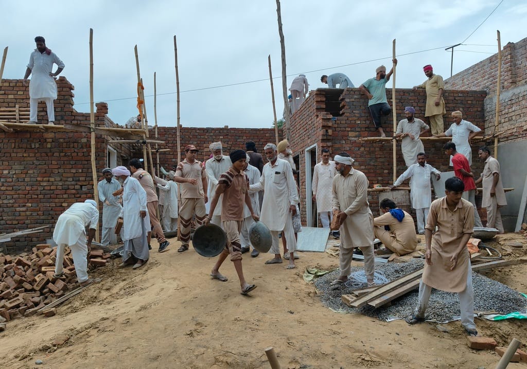 7 masons, 60 volunteers, one pledge... to ensure the woman gets a concrete house.