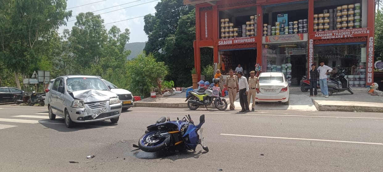 Car and bike collide violently at Dadhol Chowk; young man and woman injured.