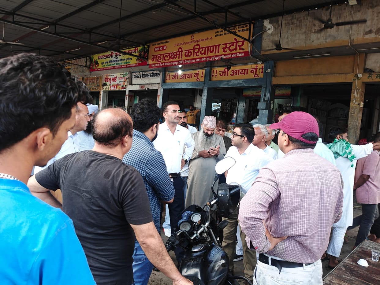 Check shop licenses and records at the vegetable market; upper-floor extensions found constructed without permission