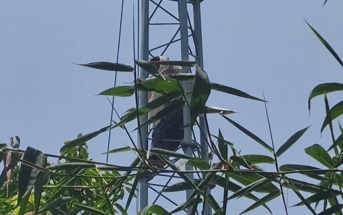Young woman climbs mobile tower, upset over friend not answering phone calls.