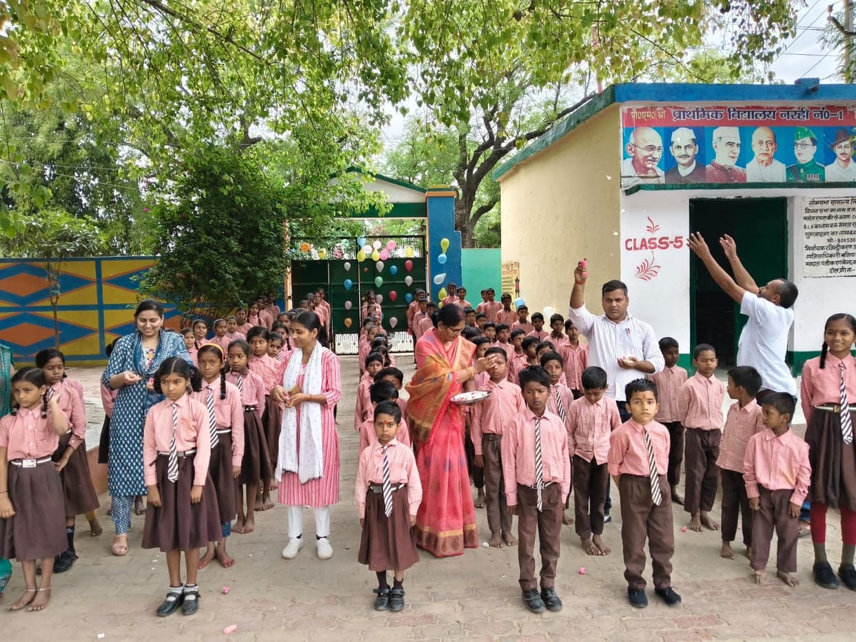 Welcomed the children by applying a tilak and showering them with flowers.
