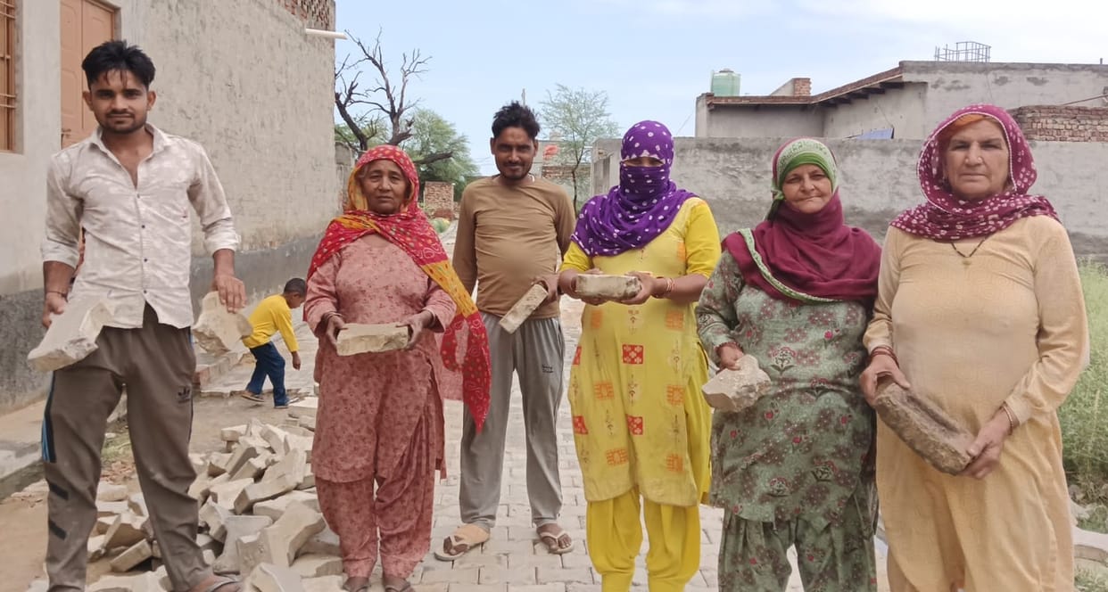 Villagers protest the use of old bricks in lane construction in Bohal.