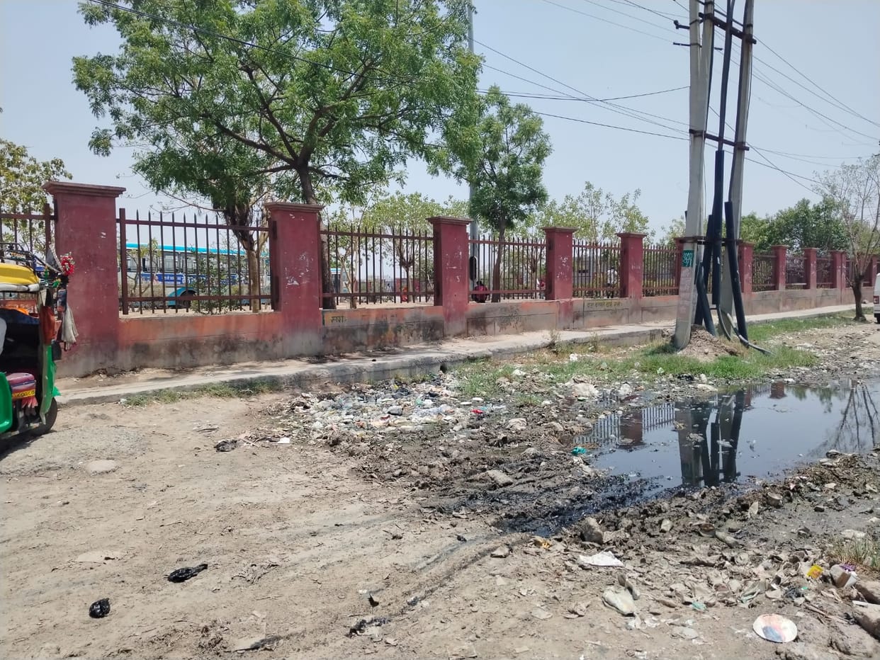People grappling with waterlogging and filth on service road