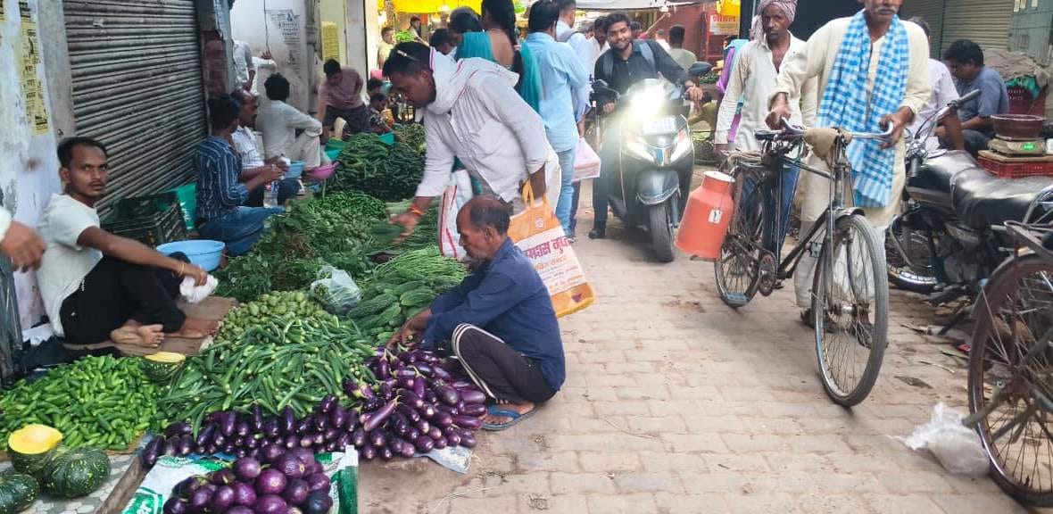 Vegetable market on the road; traffic management in disarray.