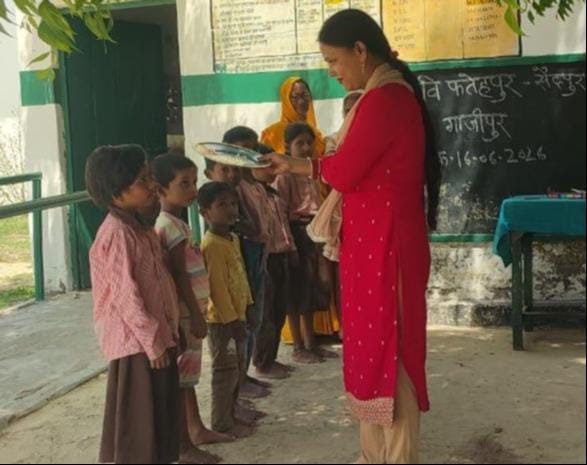 Schools reopen after 27 days of holiday, children are offered aarti with tilak.