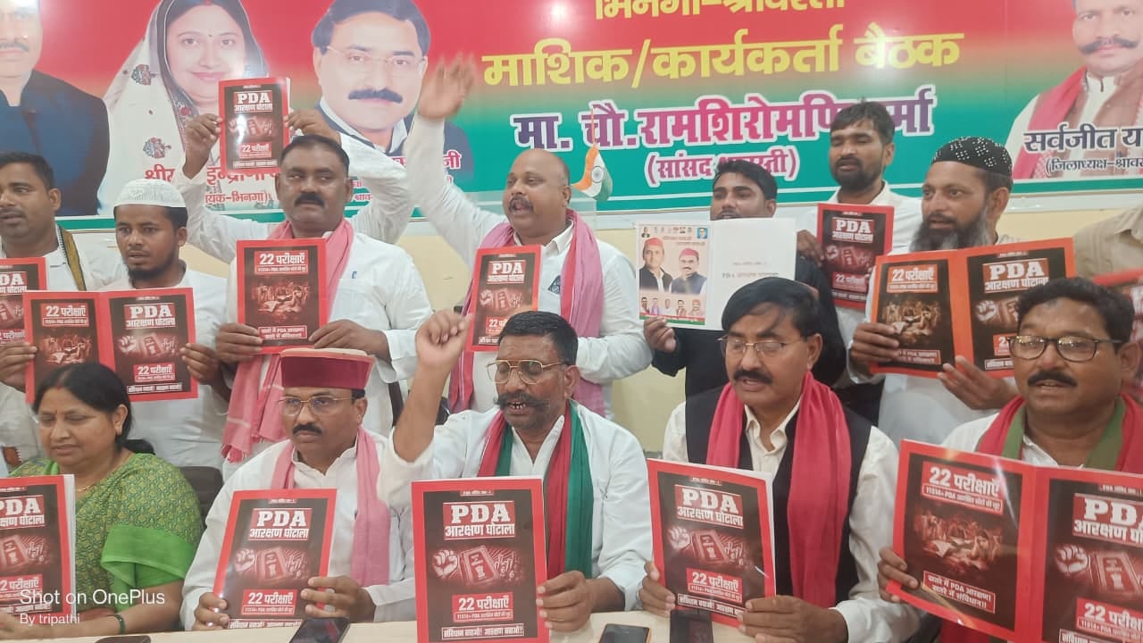 सपा कार्यालय में प्रेसवार्ता के दौरान किताब दिखाते सांसद व अन्य।
