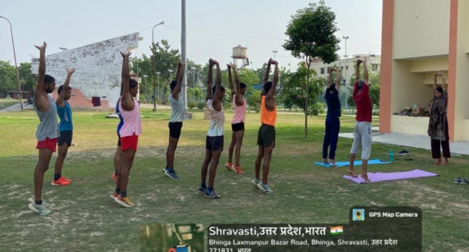 स्पोर्ट्स स्टेडियम में योग करते खिलाड़ी।