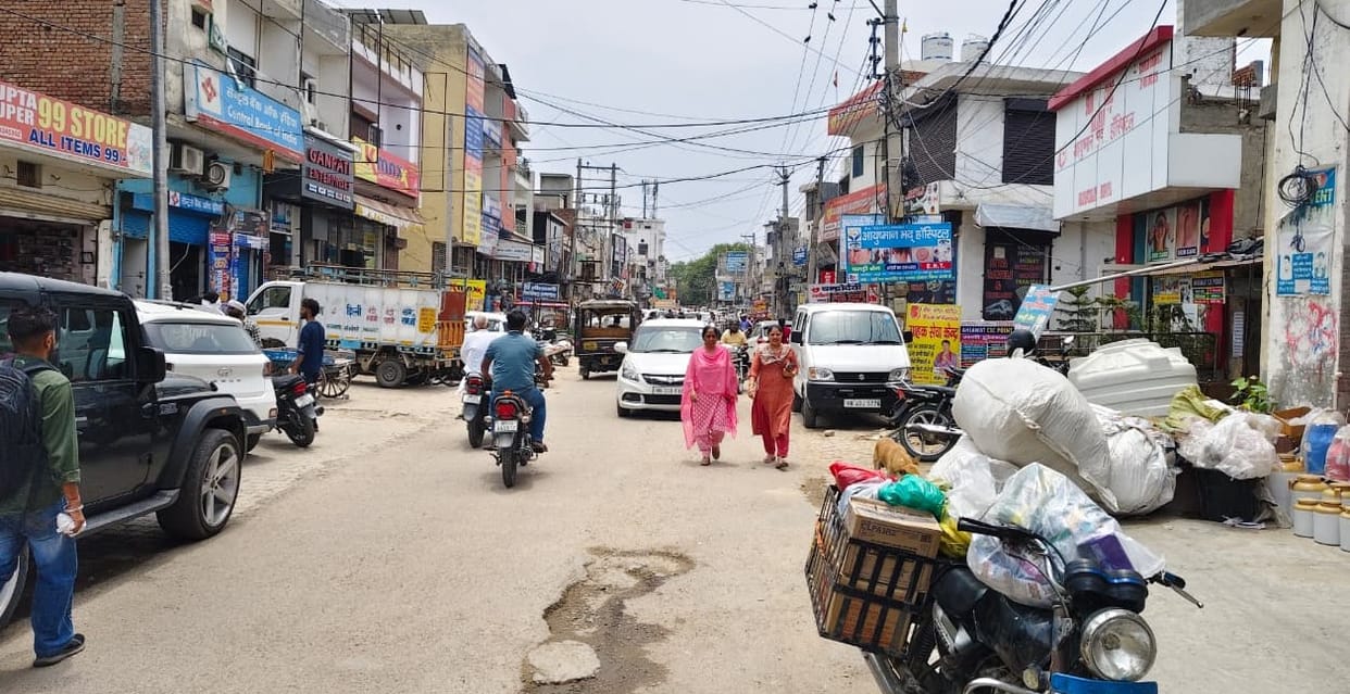Due to lack of parking facilities, drivers are parking their vehicles on the roadside.