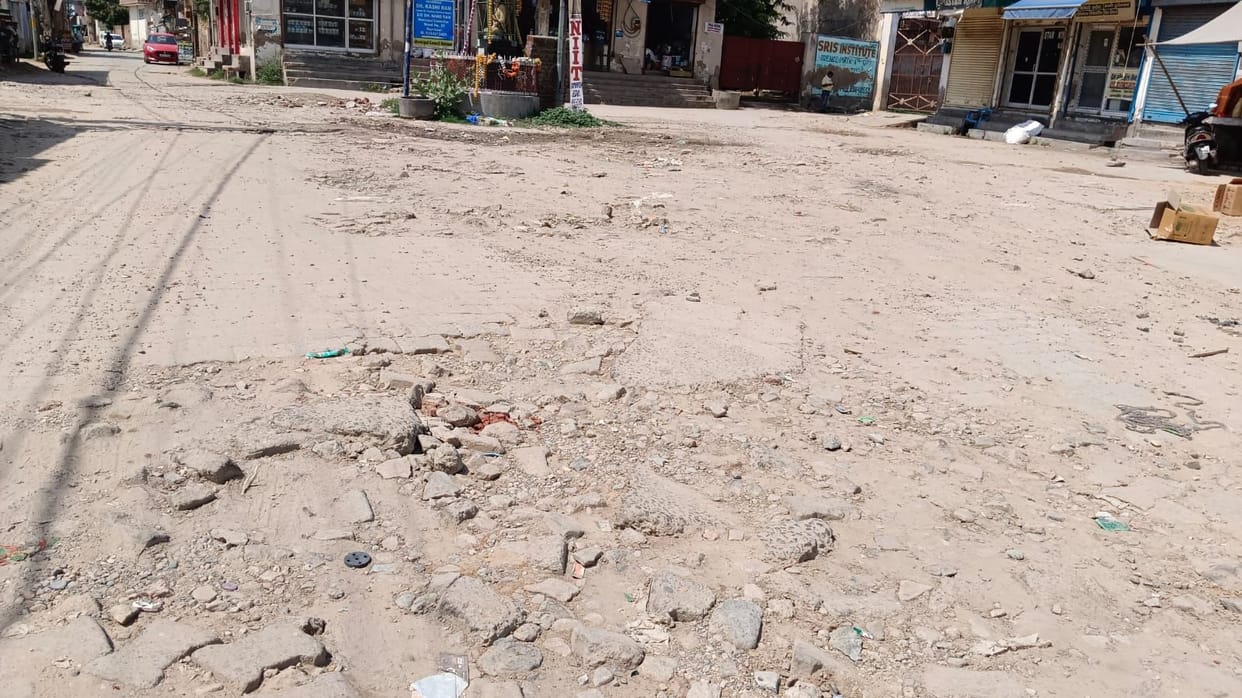 People forced to endure a bumpy ride on a dilapidated road due to the Municipal Council's lethargy.