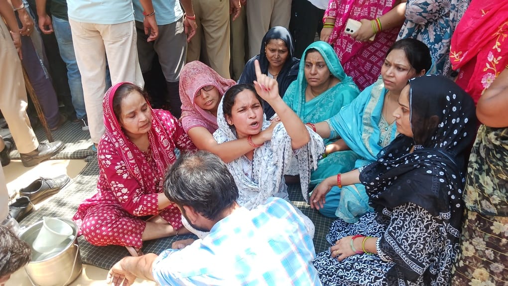 Protest at Collectorate over Sunil murder case; wife and sister lie down on the road.