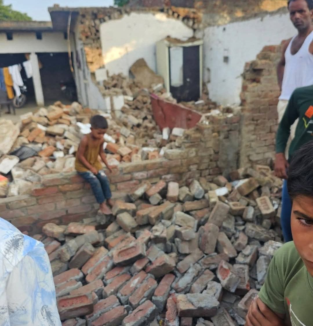 Roof of old house collapses; father and two young children trapped in debris, condition critical.
